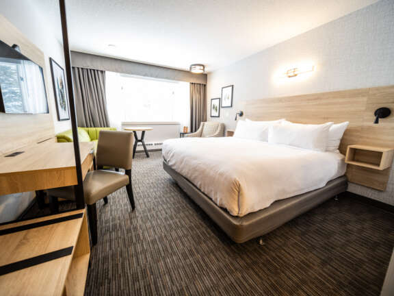 King bed room in the Main Lodge at Mountaineer Lodge, Lake Louise, steps from the lobby and hot tub.
