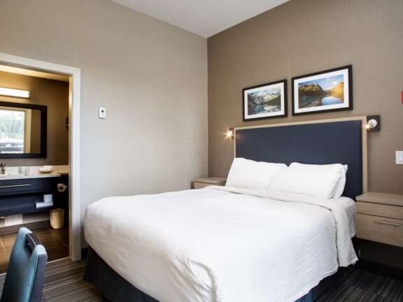 Queen room in the Timber Building at Mountaineer Lodge, Lake Louise, close to ski storage and breakfast room.
