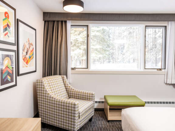 Two queen beds in the Main Lodge at Mountaineer Lodge, Lake Louise, near the hot tub and lounge.