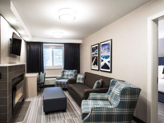 Living room area in the Mountaineer Suite with full kitchen at Mountaineer Lodge, Lake Louise, air conditioned, sleeps six.