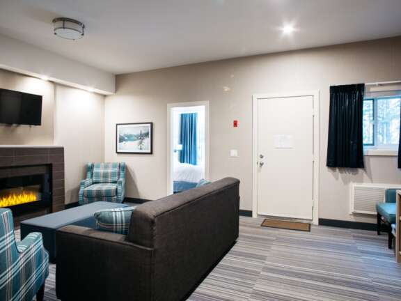 Fireplace area in the King Explorer Suite: Largest suite at Mountaineer Lodge, Lake Louise, king bed with bunk beds, 585 square feet.