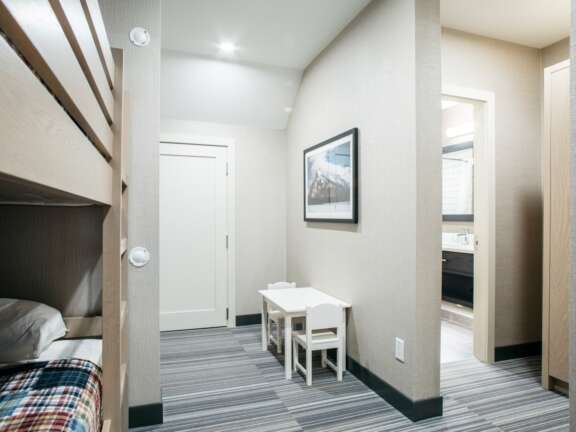 Fireplace area in the King Explorer Suite: Largest suite at Mountaineer Lodge, Lake Louise, king bed with bunk beds, 585 square feet.