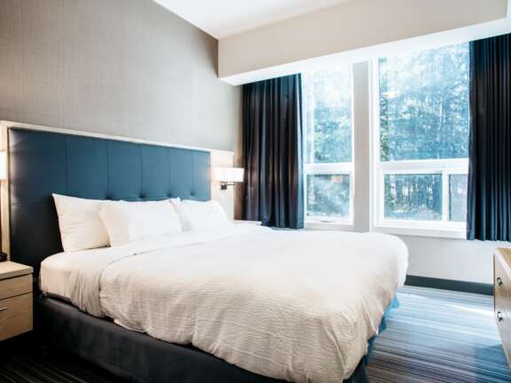 King Explorer Suite: Largest suite at Mountaineer Lodge, Lake Louise, king bed with bunk beds, 585 square feet.