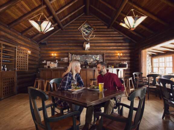Couple enjoying a meal in a mountain restaurant in Lake Louise, Banff National Park