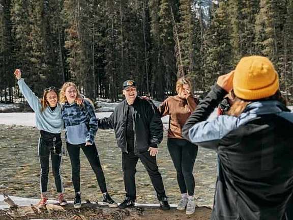 Lake Louise staff team taking a photo in front of the river