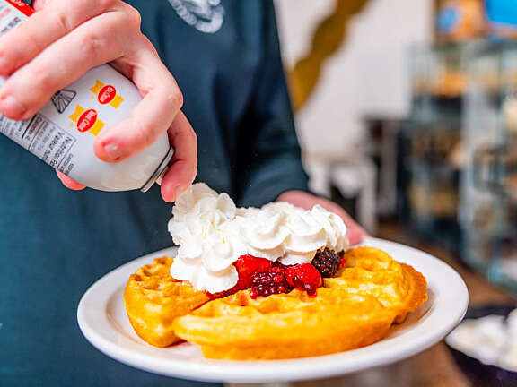 Waffles, fruit, and whipped cream make a delicious breakfast.